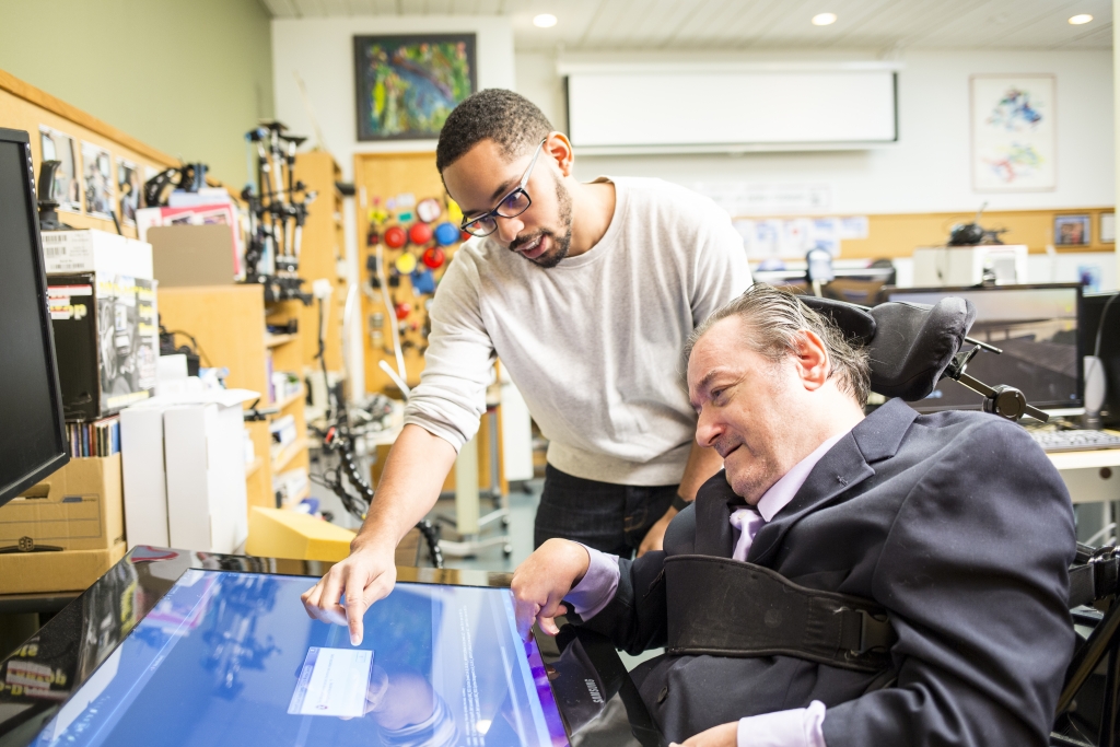 iSchool Ph.D. student Martez Mott works with participant Ken Frye to test touch-enabled devices for people with motor impairments and for people under the effects of situational impairments