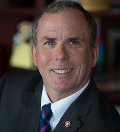 Rory A. Cooper, a white man with salt-and-pepper hair, dressed in a suit and tie.