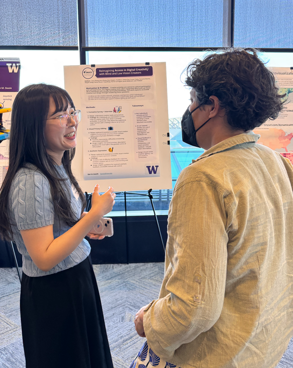 Lotus Zhang talks to Jennifer Mankoff in front of Zhang's Reimagining Accessing Digital Creativity research poster.