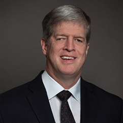 Kirk Adams in a dark suit and tie. He is a white man with salt-and-pepper grey hair.