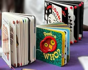 Three adapted children's board books on display at a HuskyADAPT event.