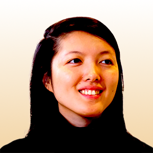 Stacy Hsueh, an Asian woman. She is smiling, looking away from the camera, against a bright background