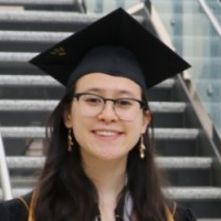 Gina Clepper, a young woman with long, brown hair wearing glasses and a graduation mortar board.