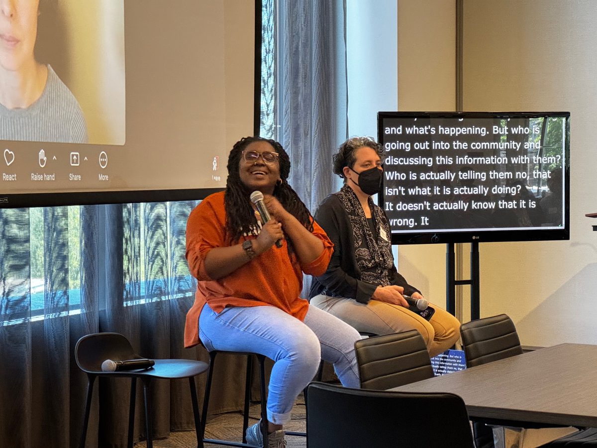 Jazette Johnson and Jennifer Mankoff seated at the front of the room during their panel discussion