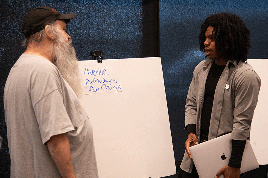 Two CREATE Accessibility Hackfest - Summer 2026 participants discuss ideas at a poster board labeled "Avenue - Pathways for Change."