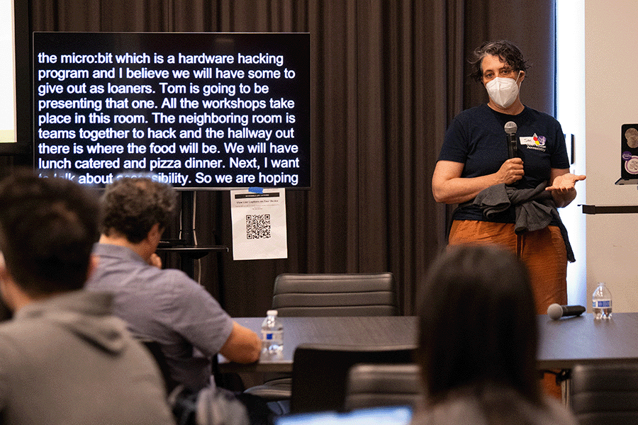 Jennifer Mankoff stands at the front of a room introducing a workshop at the CREATE Accessibility Hackfest, Summer 2026