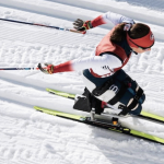 An overhead photo of Nicole Zaino using a sit-ski in a Para Nordic ski race