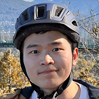 A young man with dark hair wearing a bicycle helmet.