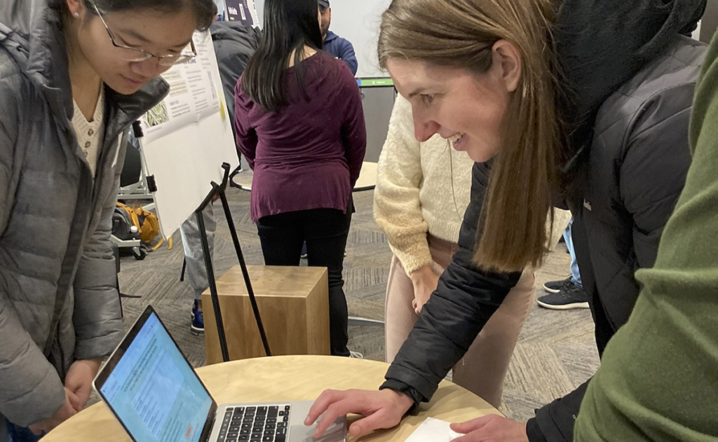 Kat Steele tries out the PadMap project on a laptop that shows where feminine hygiene can be found on the UW Seattle campus.