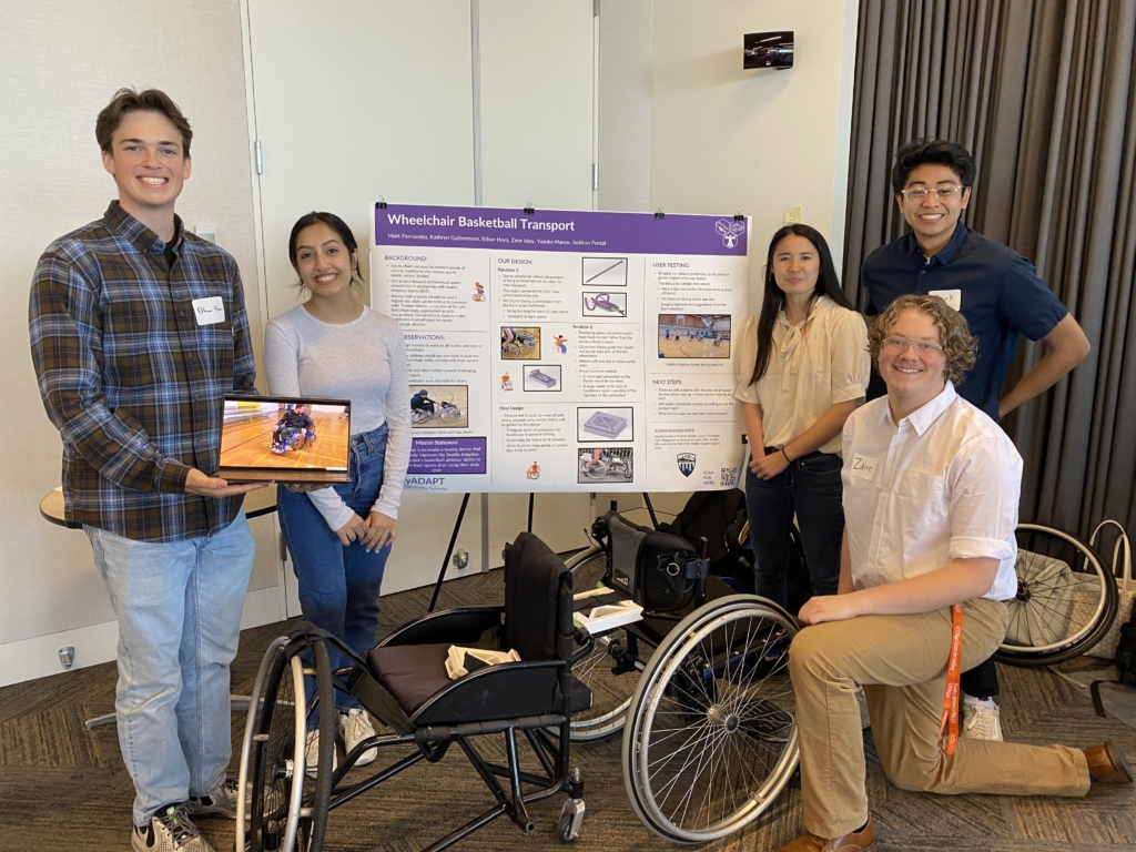 Students stand by their poster for "Wheelchair Basketball Transport."