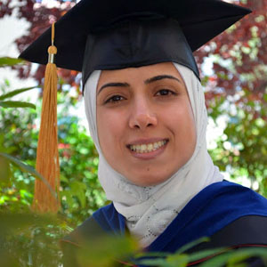 Nancy Alajarmeh, smiling and wearing a graduation cap