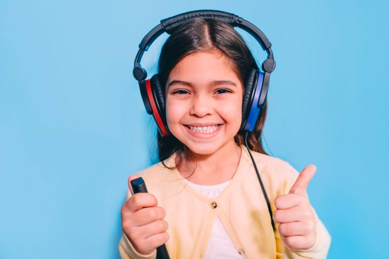 Cute mixed race child during hearing exam wears special headphones.