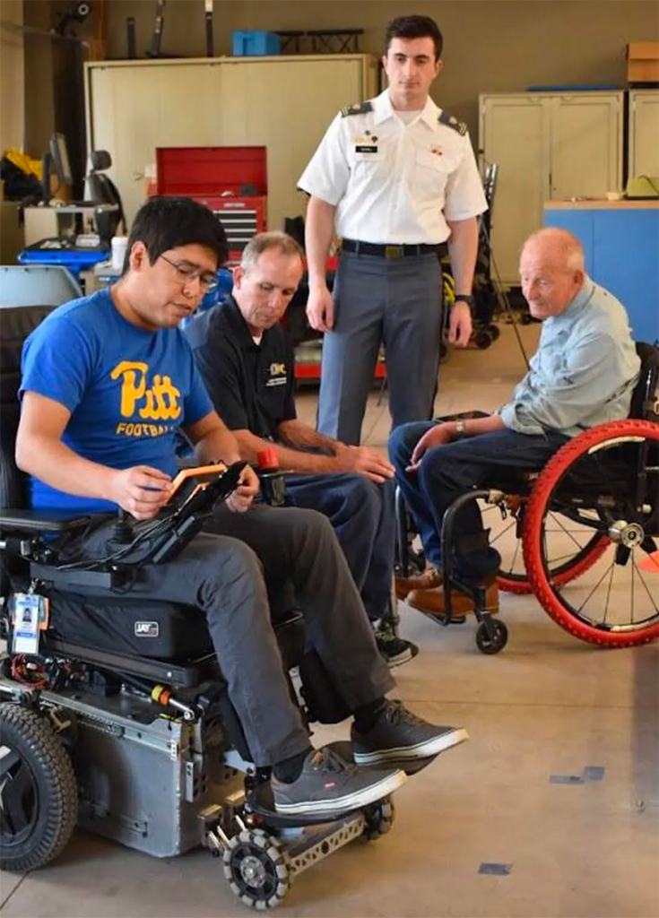 Cooper (second from the left) and his colleagues—David Constantine, Jorge Candiotti, and Andrin Vuthaj (standing)—at the University of Pittsburgh’s Human Engineering Research Laboratories working on the MEBot. Photo: ABIGAIL ALBRIGHT