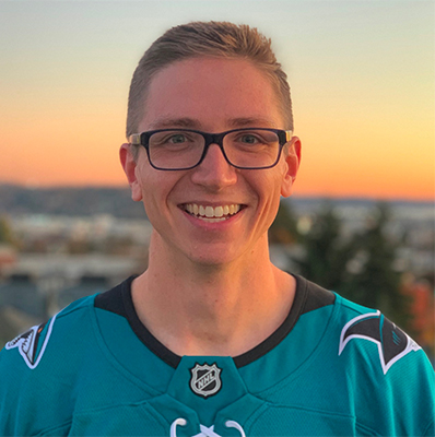 Elijah Kuska smiling with a sunset in the background